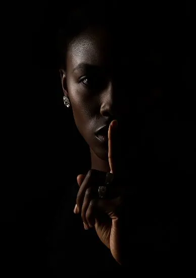 A woman holding a finger to her lips